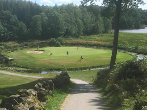 a group of people playing golf on a golf course at Sotenäs Golfhotell in Hunnebostrand