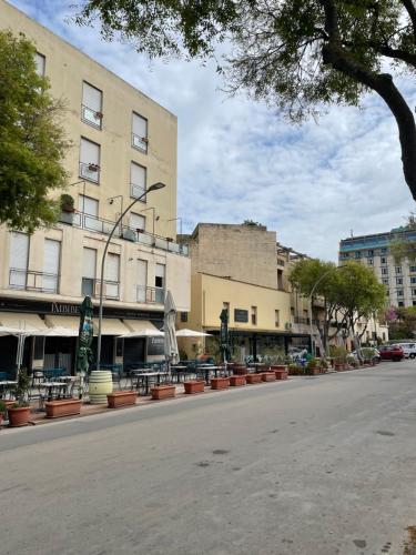 an empty street in a city with a building at Catalogna10 Rooms in Alghero