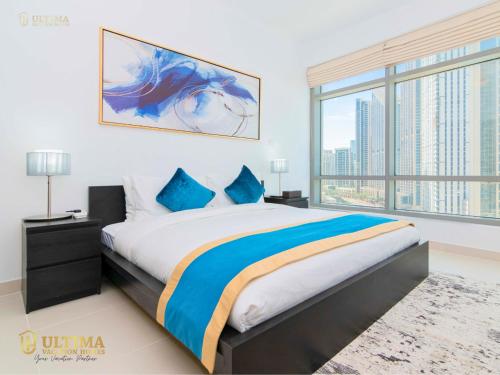 a bedroom with a large bed and a large window at Ultima Vacation Homes loft 1 BR Apartment in Dubai