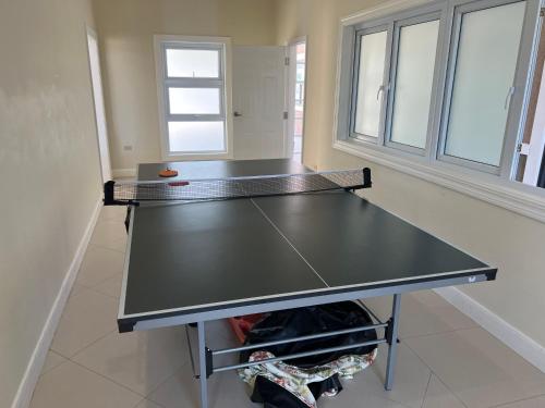 a ping pong table in the middle of a room at Serenity Get Away in Lucea