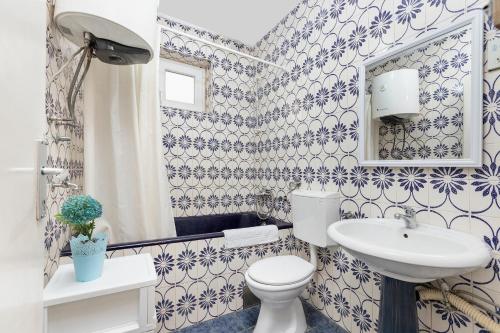 a bathroom with a white toilet and a sink at Apartments Casa Mia in Kotor