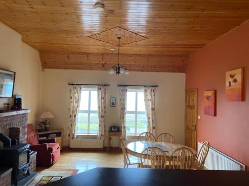 a living room with a dining room table and chairs at The Cliffs of Moher House, Doolin in Droíchead an Chláir