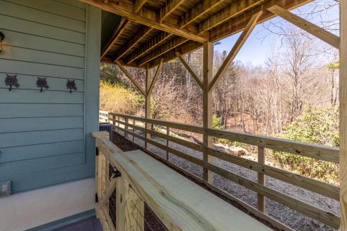 a porch of a cabin with a wooden railing at River View Retreat in Boone