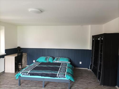 a bedroom with a bed with blue walls at Apartmán Veselé in Děčín