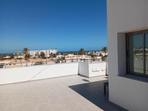 a balcony with a view of the beach and buildings at Résidence Inès Djerba Appartements VIP in Houmt Souk