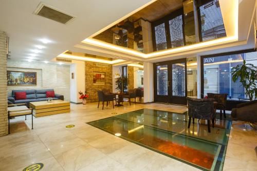 a large living room with a glass table in it at P Galata Hotel - Special Category in Istanbul