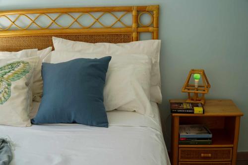 een bed met een blauw kussen en een bijzettafel bij Casa Elsa Terrazza con vista by ItalianHost in Maiori