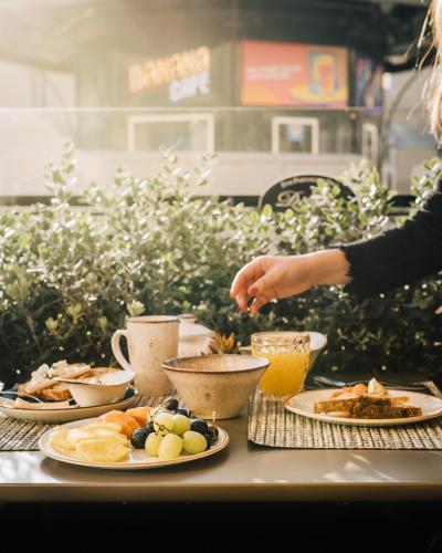 a table with plates of food and cups of coffee at AlmaLusa Baixa/Chiado in Lisbon