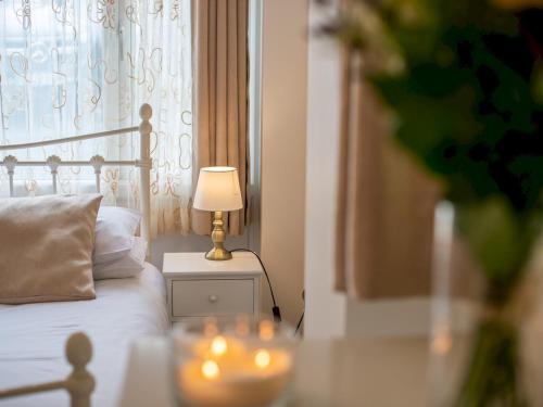 um quarto com uma cama com um candeeiro sobre uma mesa em Pass the Keys Beautiful apartment with stunning views em Worcester