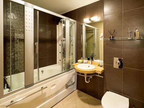 a bathroom with a sink and a shower and a toilet at Hotel Dream in Sofia