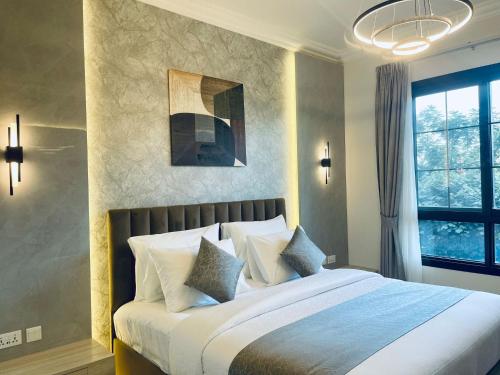 Кровать или кровати в номере GOODWOOD SUITES HOMES VACATION