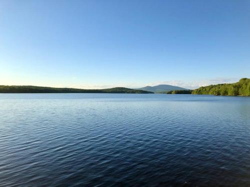 a large body of water with mountains in the background at The Brookside Lodge & Cottage in Dover