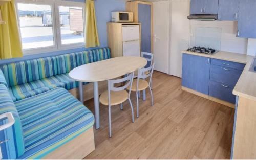 a kitchen with a table and a couch and a table at DOMAINE DE LA GRANGE DES CHAMPS in Lorris