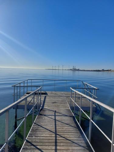 a dock on a body of water at KRAGKAER Deer-Lodge B&B & Guest House - Unique Holiday Homes in Sæby