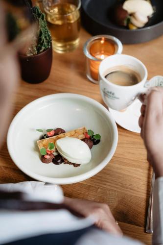 a bowl of food and a cup of coffee on a table at Leerhotel Het Klooster in Amersfoort