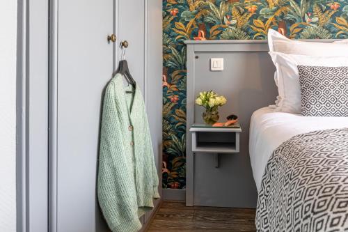 a bedroom with a bed with a green and white blanket at Splendid Hôtel in Paris