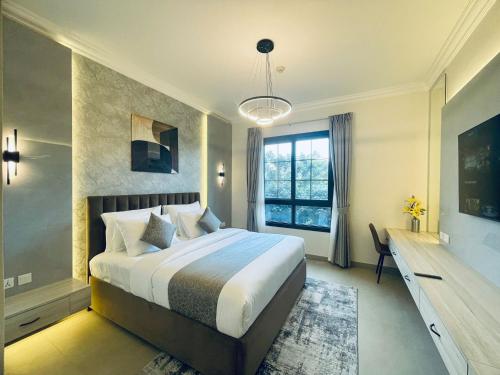 Кровать или кровати в номере GOODWOOD SUITES HOMES VACATION