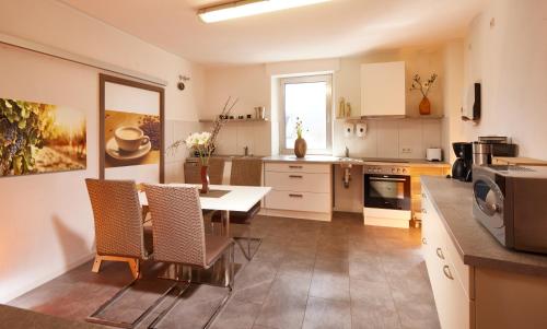 a kitchen with a table and chairs in a room at Hotel zum Stern in Schweich