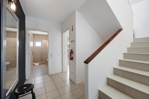 a staircase leading to a bathroom with a stair case at Villa Roxana in Porches