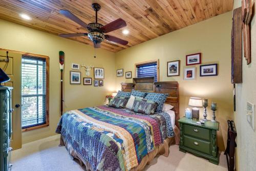 a bedroom with a bed and a ceiling fan at Flag Hole Riverfront Cabin Near Local Attractions! in Glenwood
