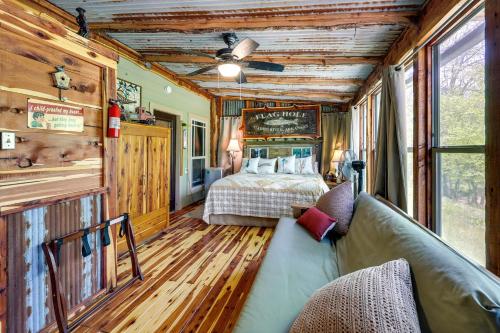 a bedroom with a bed and a couch in a room at Flag Hole Riverfront Cabin Near Local Attractions! in Glenwood