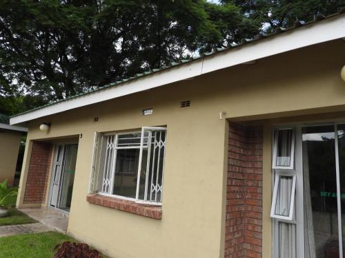 a house with a window on the side of it at 2 bedroomed apartment with en-suite and kitchenette - 2065 in Harare