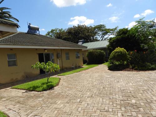 a driveway in front of a house at 2 Bed Apt with en-suite and kitchenette - 2066 in Harare