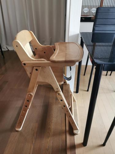 a wooden high chair sitting next to a table at 心遊亭Shin Yu Tei 一軒雅宿 in Kanazawa