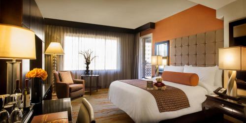 a hotel room with a large bed and a chair at Golden Nugget Lake Tahoe in Stateline