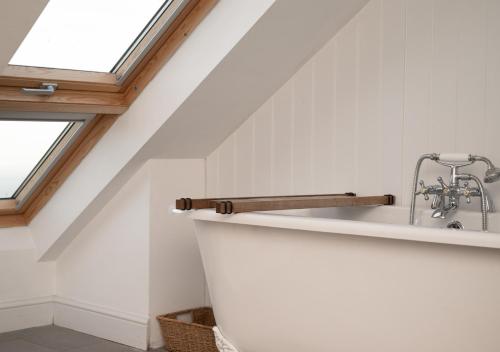 a bathroom with a sink and a window at Lower Coastguard Cottage in Hastings