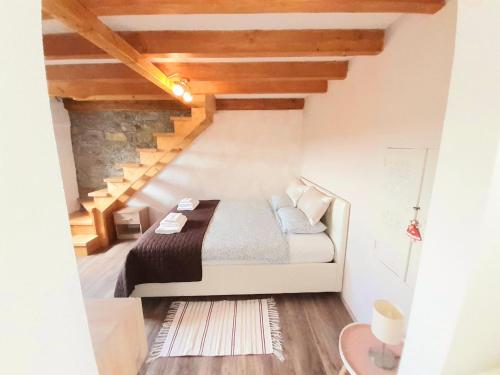a bedroom with a bed in a room with stairs at Apartment Vignole in Portorož