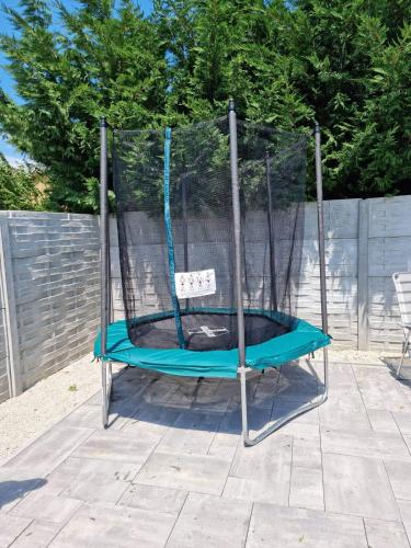 a blue swing in the middle of a yard at Wellness Villa Diana in Boldogkőváralja