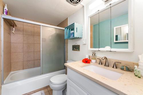 a bathroom with a sink and a toilet and a shower at Keauhou Akahi 302 in Kailua-Kona