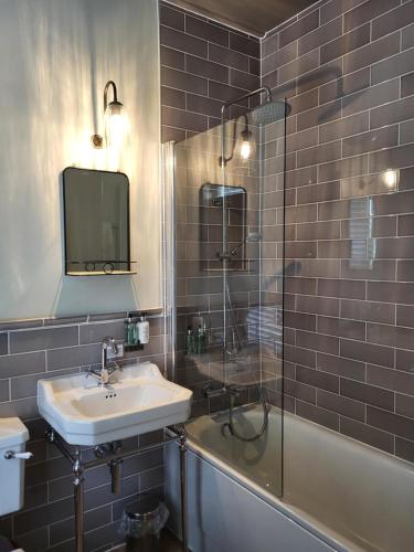 a bathroom with a sink and a shower at The Black Hat in Ilkley