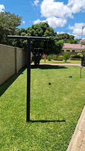 a pole in the middle of a field of grass at Posh 3 bedroomed guesthouse in Hillside with pool - 2039 in Bulawayo