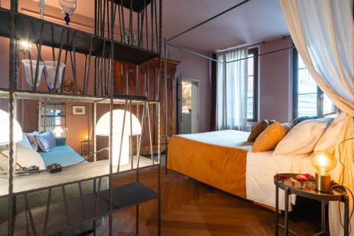 a bedroom with a bed and a large window at Cà dei Dalmati - the Blue Canal View in Venice