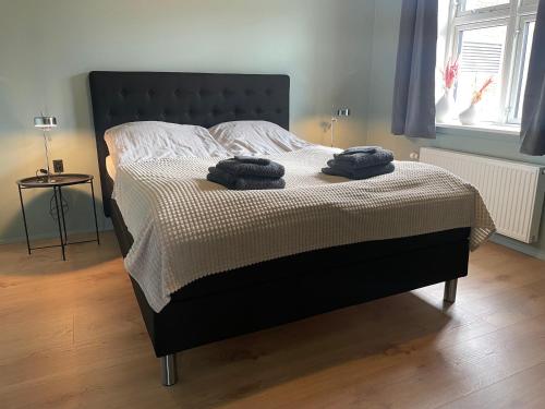 a bedroom with a bed with two towels on it at Randalín in Åkirkeby