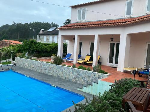 a villa with a swimming pool and a house at Citrus Tree House, private pool and garden. in Angeja