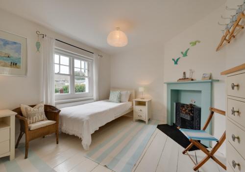a bedroom with a bed and a fireplace at Napier Cottage in Broadstairs