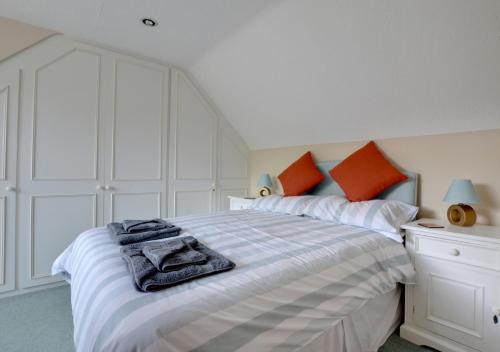a bedroom with a bed with towels on it at Stable Mews Cottage in Royal Tunbridge Wells