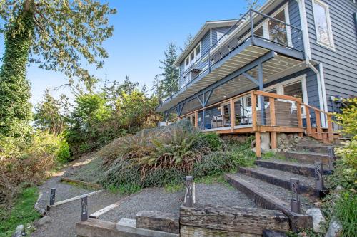 a house with stairs leading up to a porch at Olympus View Home in Port Ludlow