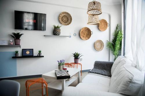 a living room with a white couch and a table at Let me take my bunk bed in Athens