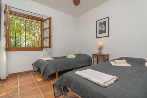 a room with two beds and a window at Tres Mares in Cala Bona