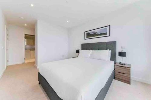 a large white bedroom with a large white bed at Modern & Spacious Luxury Flat-10 min to London Eye in London
