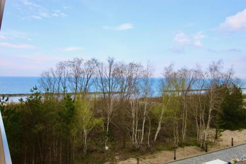 a view of the ocean from the balcony of a house at Apartamenty Solaris in Darłówko