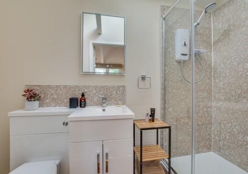 a bathroom with a sink and a shower at The Garden Cottage in Nutley