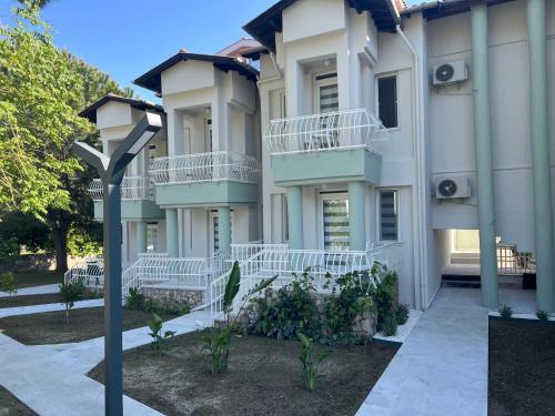 a building with white balconies and a street light at Göcek Selya Hotel in Göcek