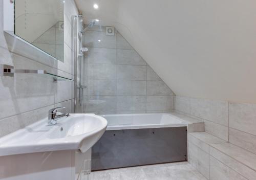 a white bathroom with a sink and a shower at The Honey Pot in Lyminge