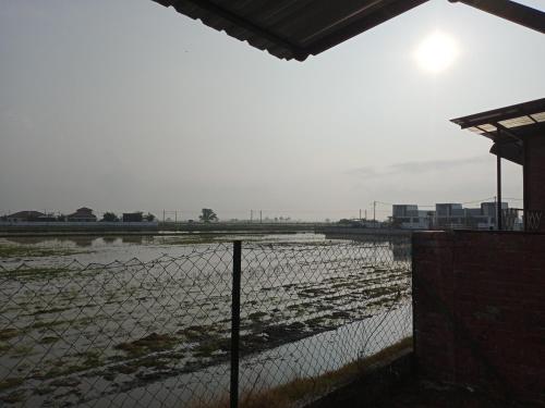 a fence in front of a body of water at MY KIJANG HOMESTAY - Banglo, Alor Setar Kedah DarulAman in Alor Setar