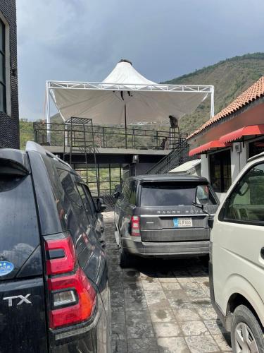 a group of cars parked in a parking lot at Hotel La Orilla Muzaffarabad in Muzaffarabad